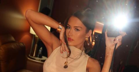 Brooke Schofield taking a mirror selfie with a camera with flash