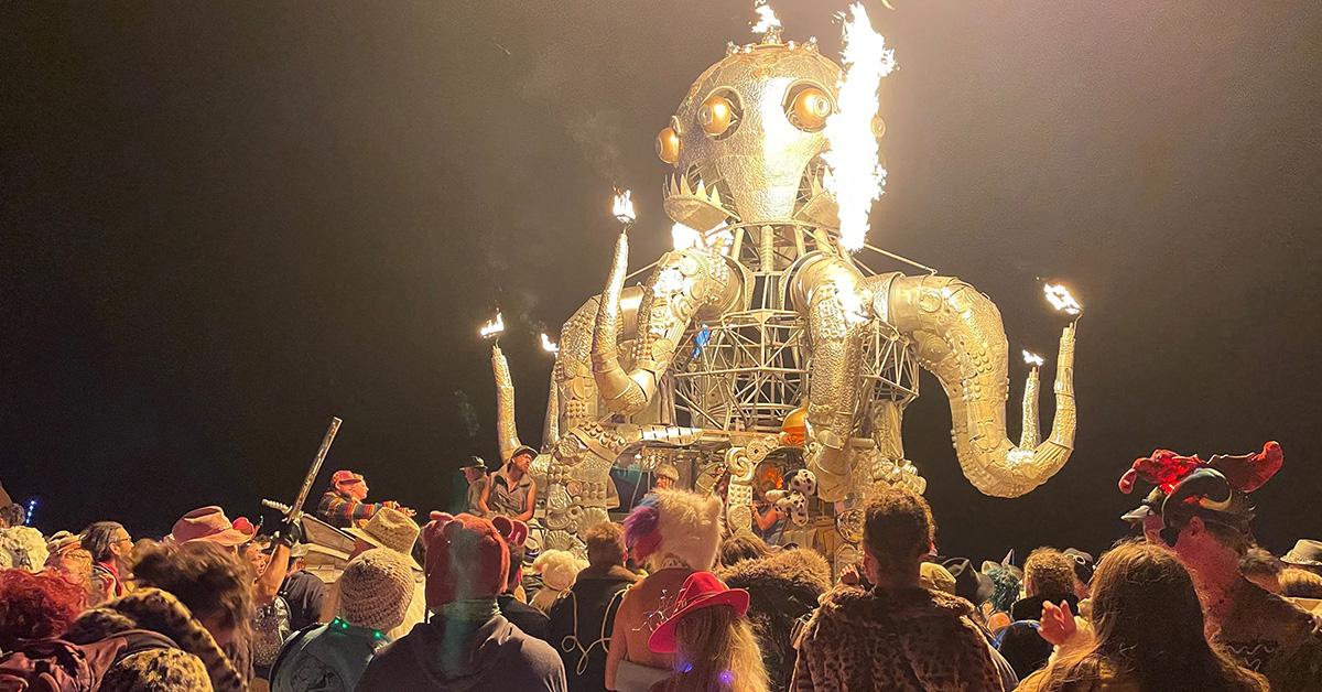 Festival-goers dance during the final night of Burning Man, 2023. 