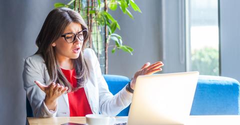 woman office worker frustrated at laptop