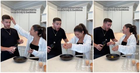 Woman and man laugh after she uses his head to crack an egg.