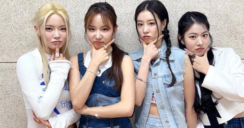 FIFTY FIFTY with their hands on their chins.