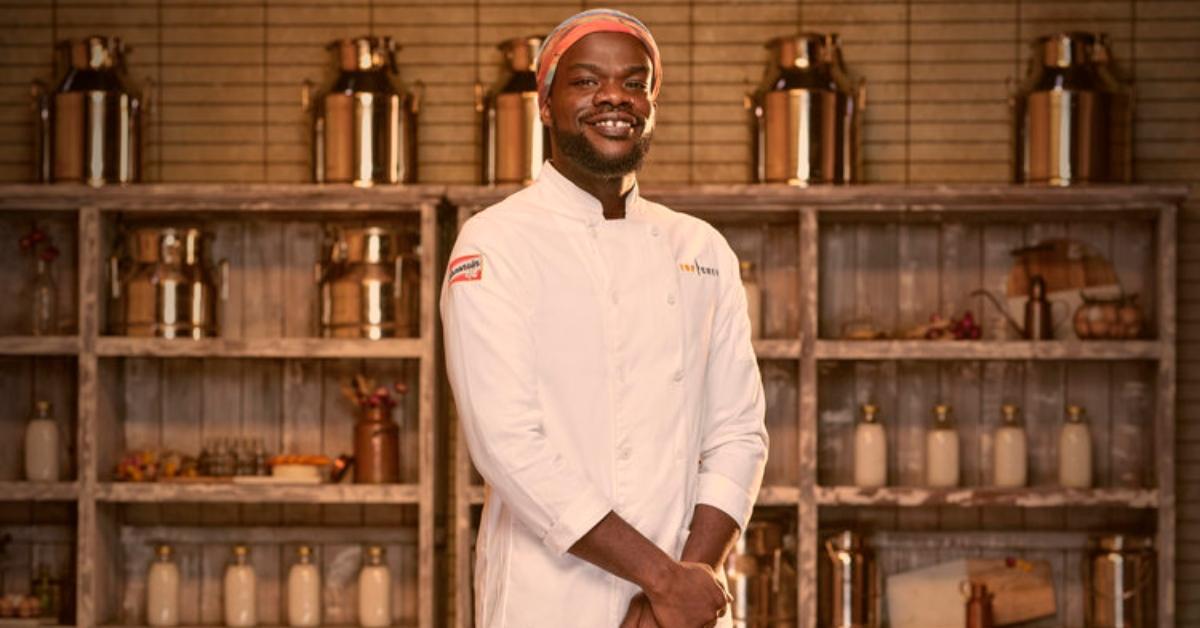 Charly Pierre wears a white chef's jacket for his official 'Top Chef: Wisconsin' portrait