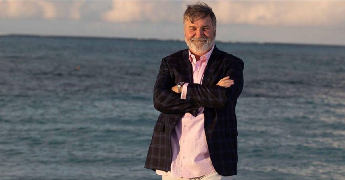 Todd Bradley poses for a photo on the beach