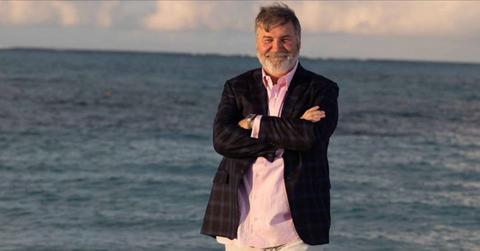 Todd Bradley poses for a photo on the beach