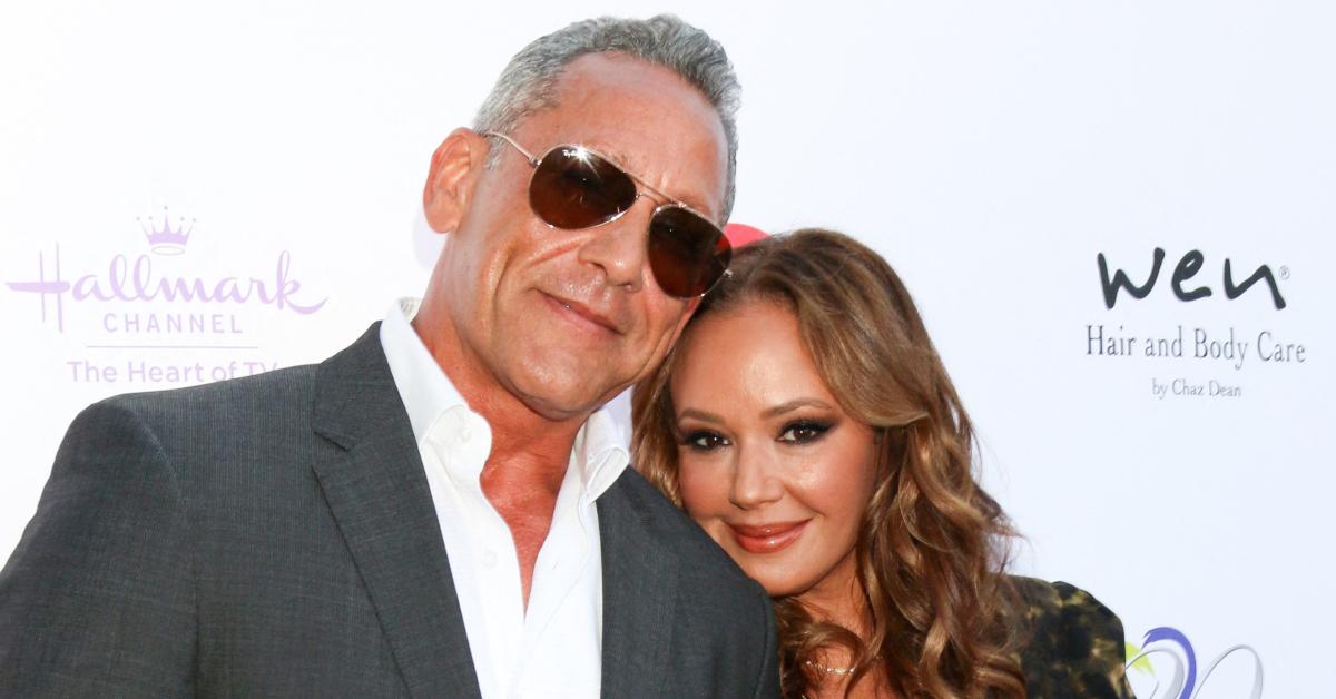 Angelo Pagán poses on a red carpet with his now ex-wife, Leah Remini.