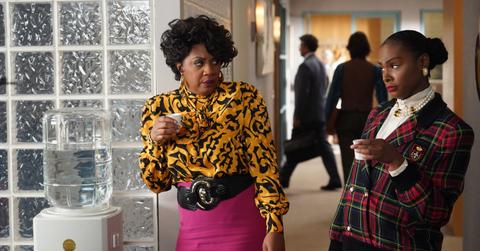 Denise and Alicia standing at the water cooler at work.