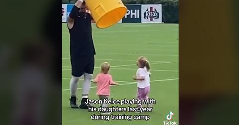 Jason Kelce playing with his daughters during Philadelphia Eagles training camp.