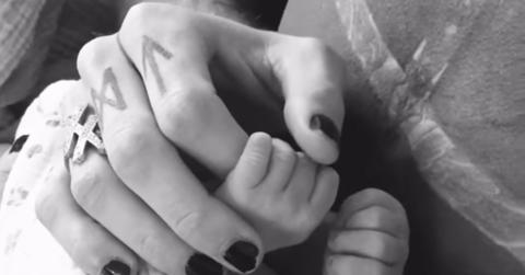 Machine Gun Kelly holds his daughter's hand