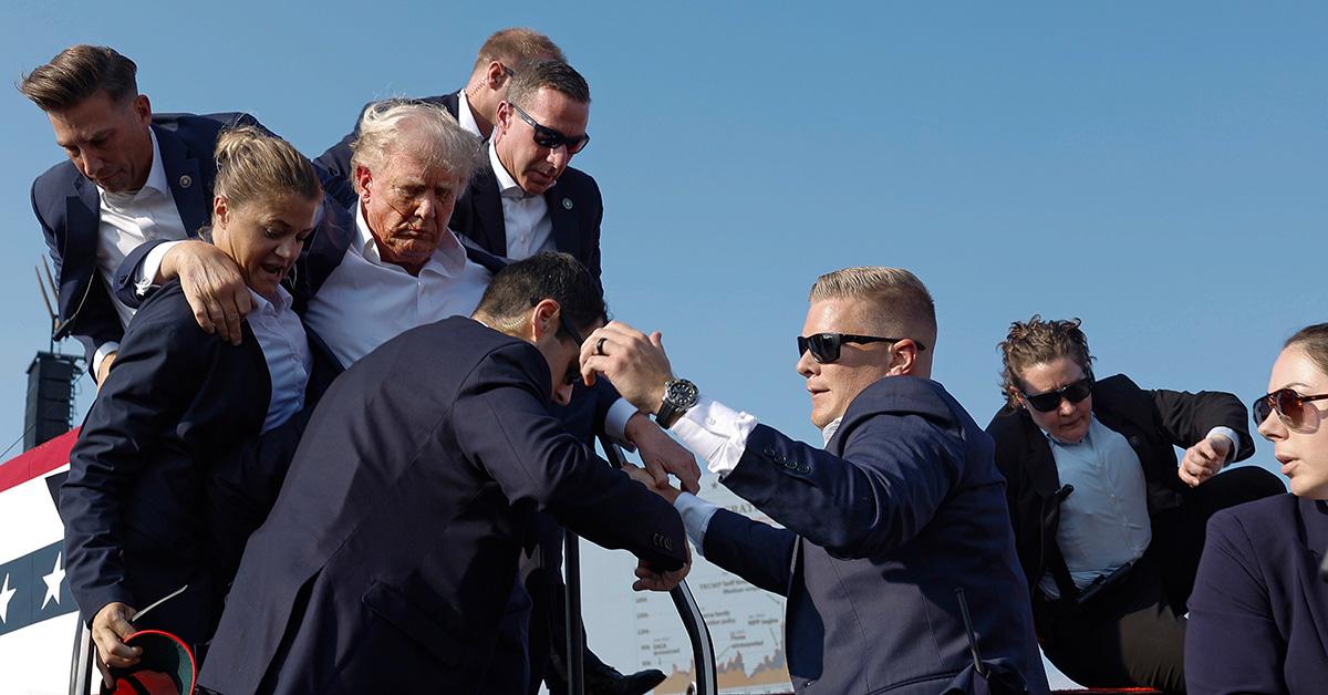 Donald Trump being escorted off the stage at a July 13 political rally. 