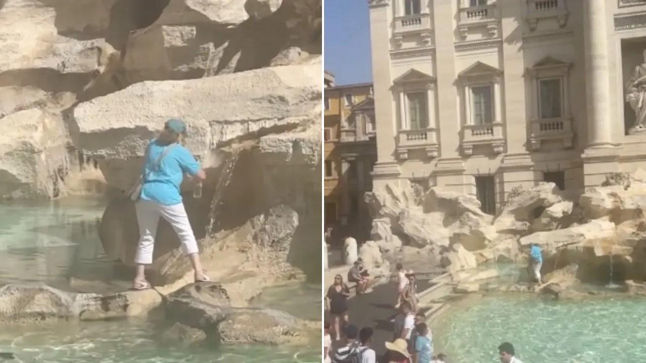 A tourist climbs Trevi Fountain to fill a water bottle