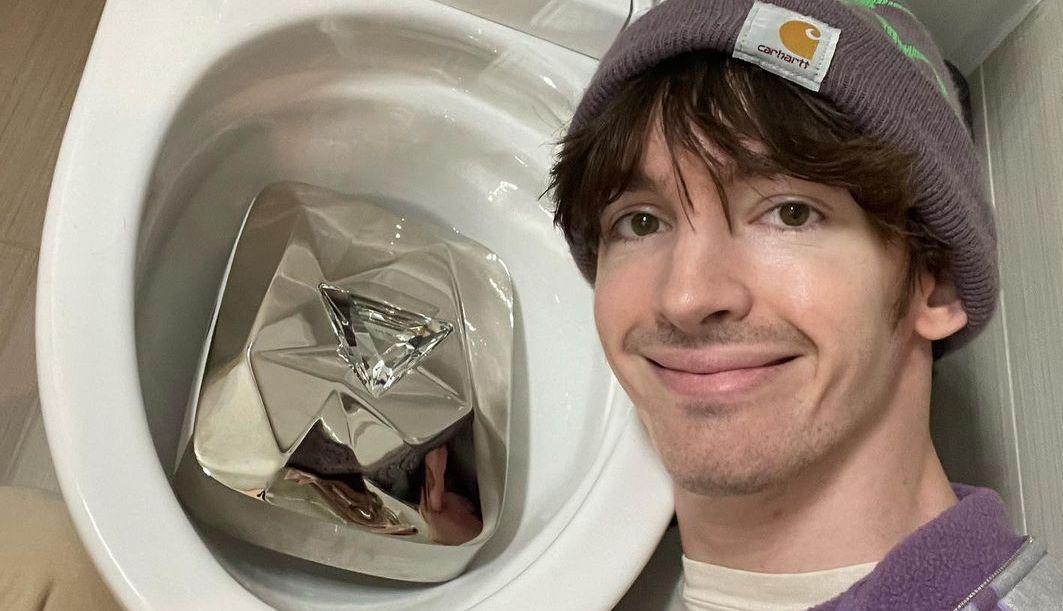 Flamingo the YouTuber with his platinum play button in the toilet.