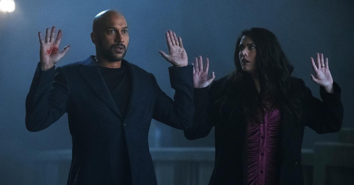 Keegan Michael-Key and Cecily Strong looking afraid while being held up in Season 2 of 'Schmigadoon!'.