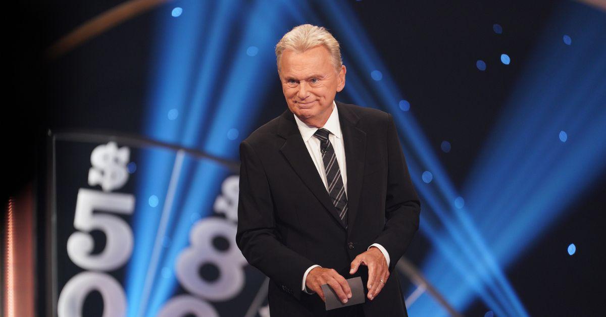Pat Sajak hosting 'Celebrity Wheel of Fortune' in a black suit and striped tie