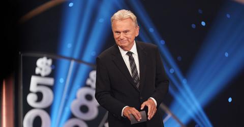 Pat Sajak hosting 'Celebrity Wheel of Fortune' in a black suit and striped tie
