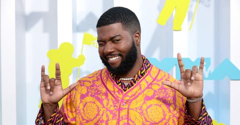 Khalid smiles and gestures rock star sign at the 2022 VMA Awards.