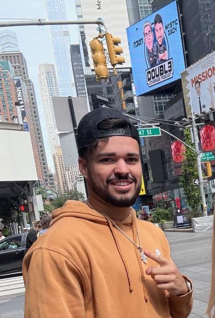 N3on poses in front of 'Doubl3 Coverage' billboards in New York City