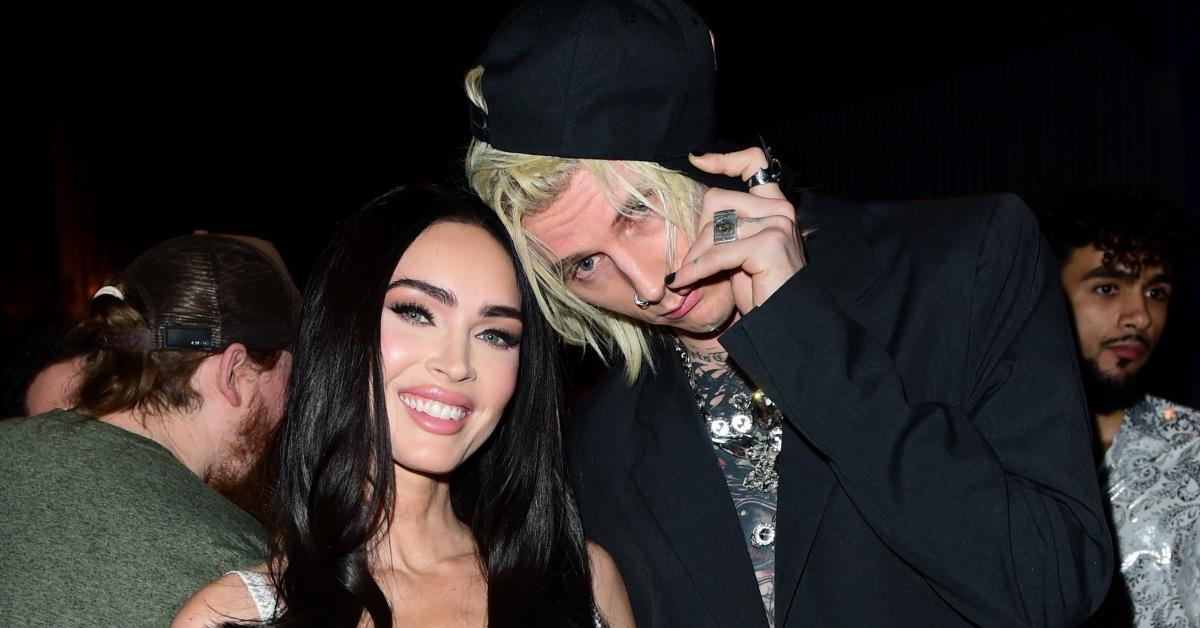 Megan Fox in a white tank and Machine Gun Kelly in a black blazer.