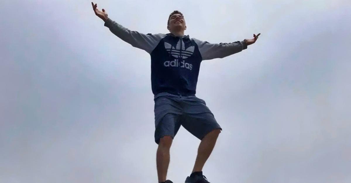 Luigi Mangione stands on a rock