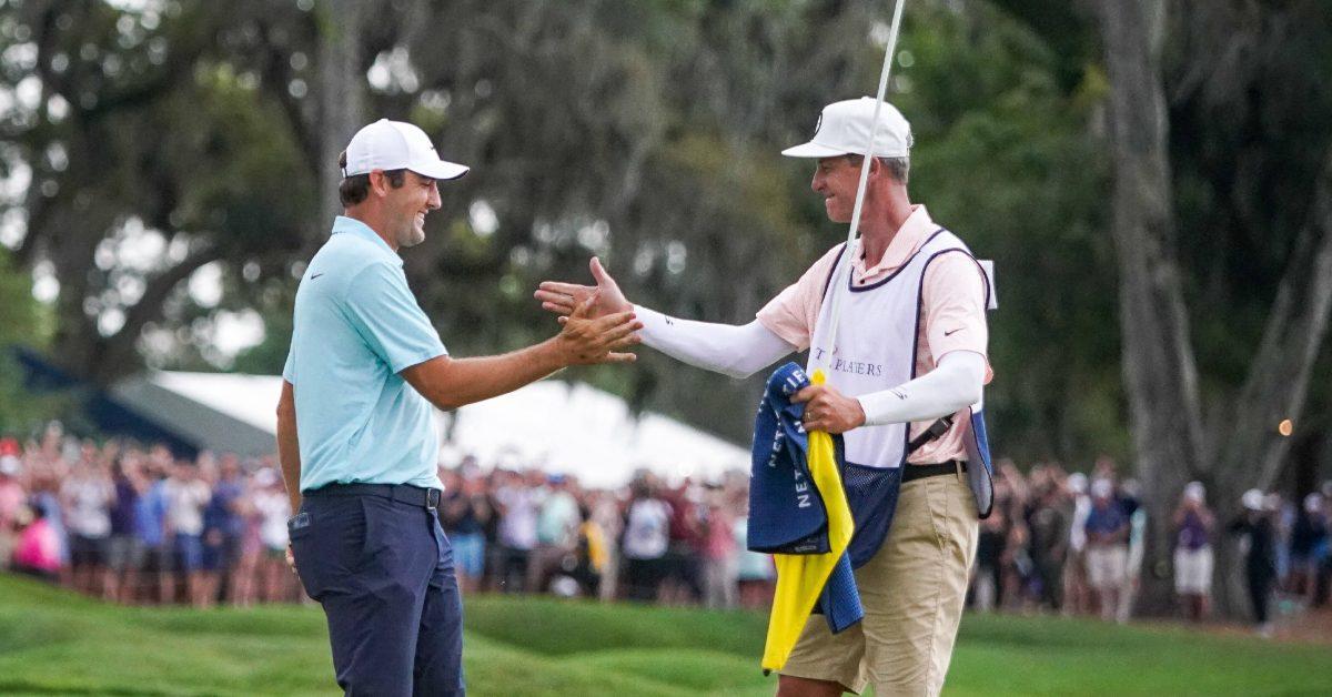 Scottie Scheffler claps hands with caddie Ted Scott.