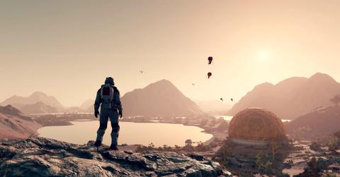 'Starfield' Astronaut standing on a cliff overlooking an outpost and lake.