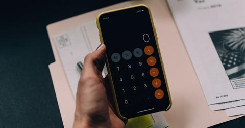 A woman holding a calculator