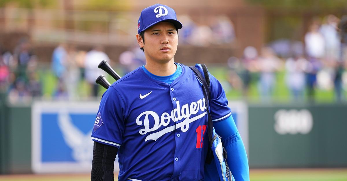 Shohei Ohtani wearing bats on his back in a Dodgers jersey. 