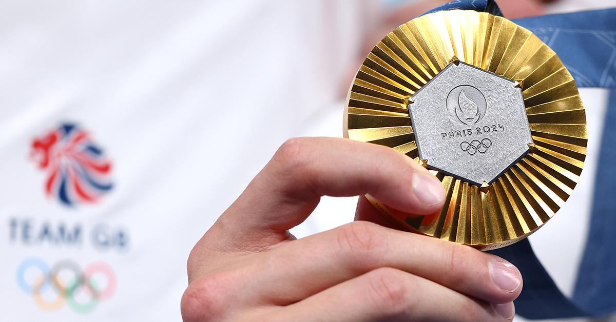 A person holding a gold medal at the 2024 Paris Olympics. 