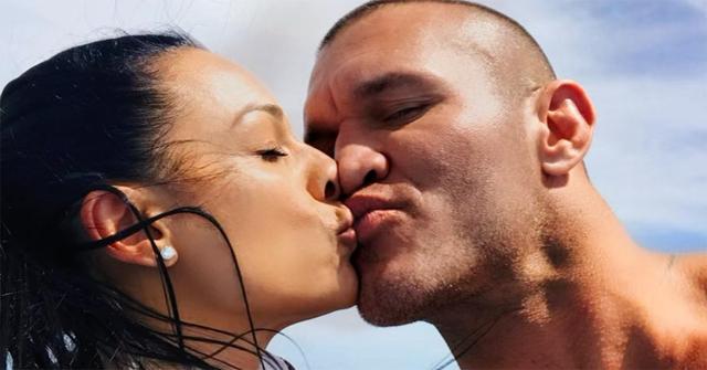 Randy Orton and his wife kissing in Bora Bora.