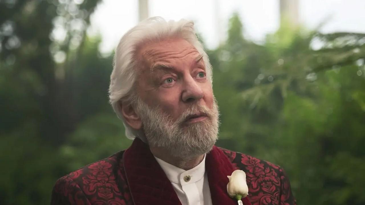 President Snow in a burgundy suit in 'The Hunger Games'