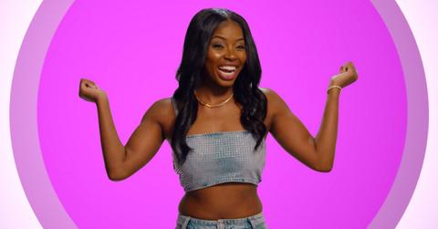 Quori-Tyler "QT" Bullock smiles and poses in front of a pink background for Season 6 of 'The Circle.'