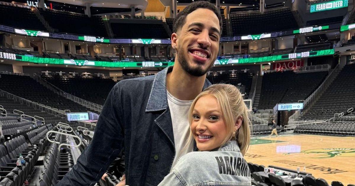 Tyrese Haliburton and Jade Jones on the basketball court hugging and smiling 