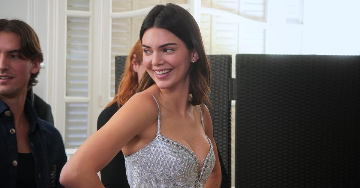 Kendall Jenner smiles over her shoulder during a fitting for Paris Fashion Week in the Season 5 premiere of 'The Kardashians.'