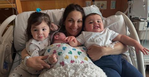 Johnny Gaudreau's widow, Meredith, posing with her three kids in a hospital bed.