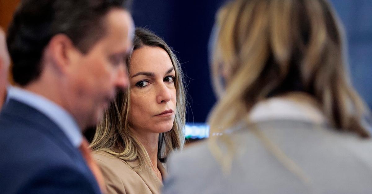 Karen Read in tan jacket stares at defense attorneys Alan Jackson and Elizabeth Little during murder trial recess