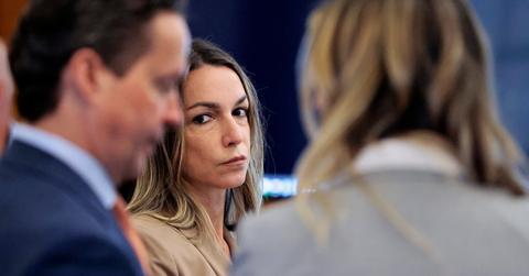 Karen Read in tan jacket stares at defense attorneys Alan Jackson and Elizabeth Little during murder trial recess