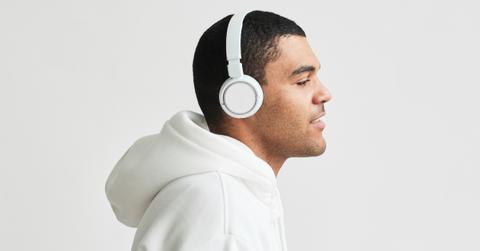 A man wears noise canceling headphones.