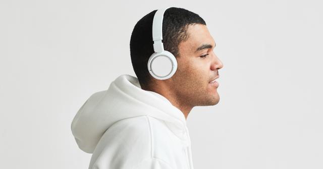 A man wears noise canceling headphones.