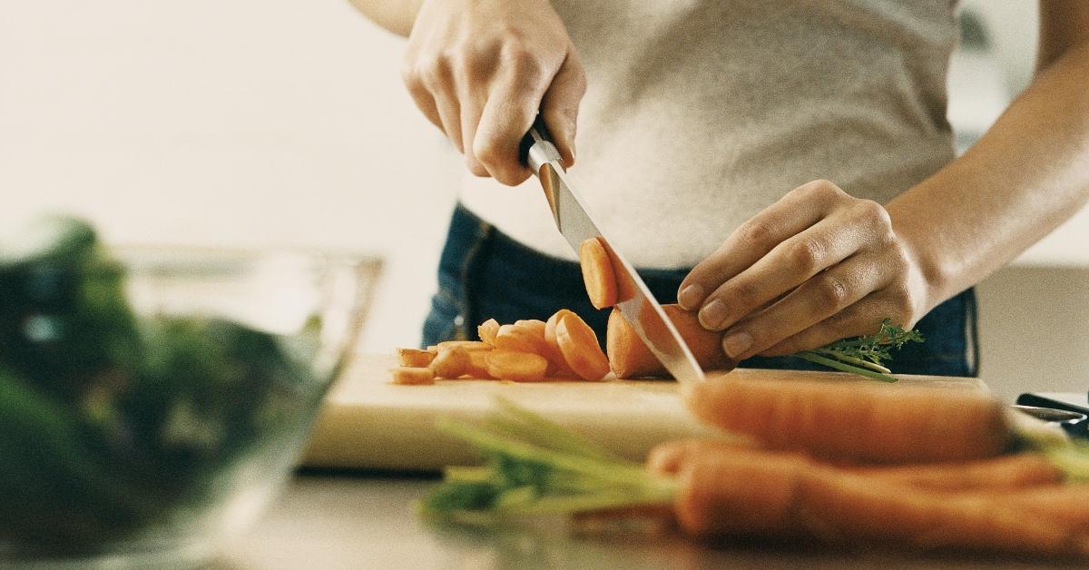 woman chopping up carrots