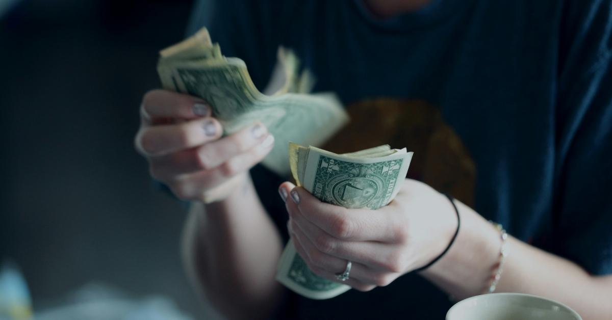 Person counts $1USD bills
