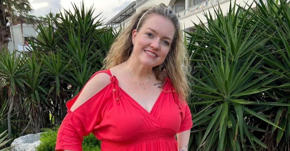 Colleen Hoover wearing a red dress.