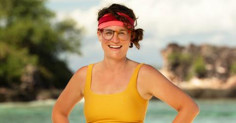 Liz Wilcox in a yellow tank top and headband.
