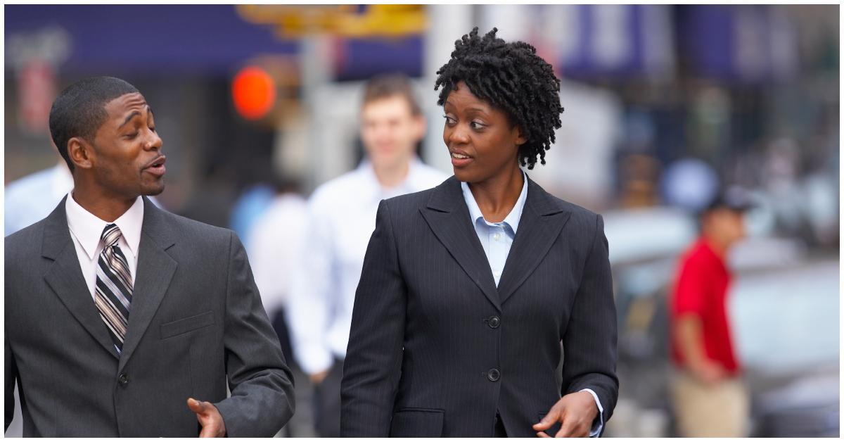 (l-r): A Black man and woman talking