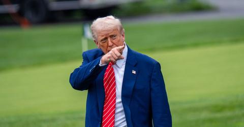 Donald Trump pointing while leaving the White House.