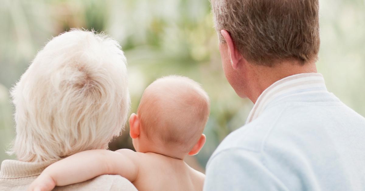 Grandparents holding their grand baby. 