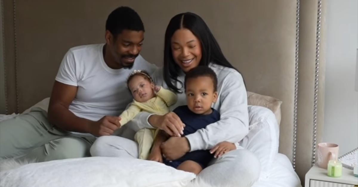 Kam Williams with her fiancé, Leroy, and their two kids cuddling in bed on Mother's Day 2024.