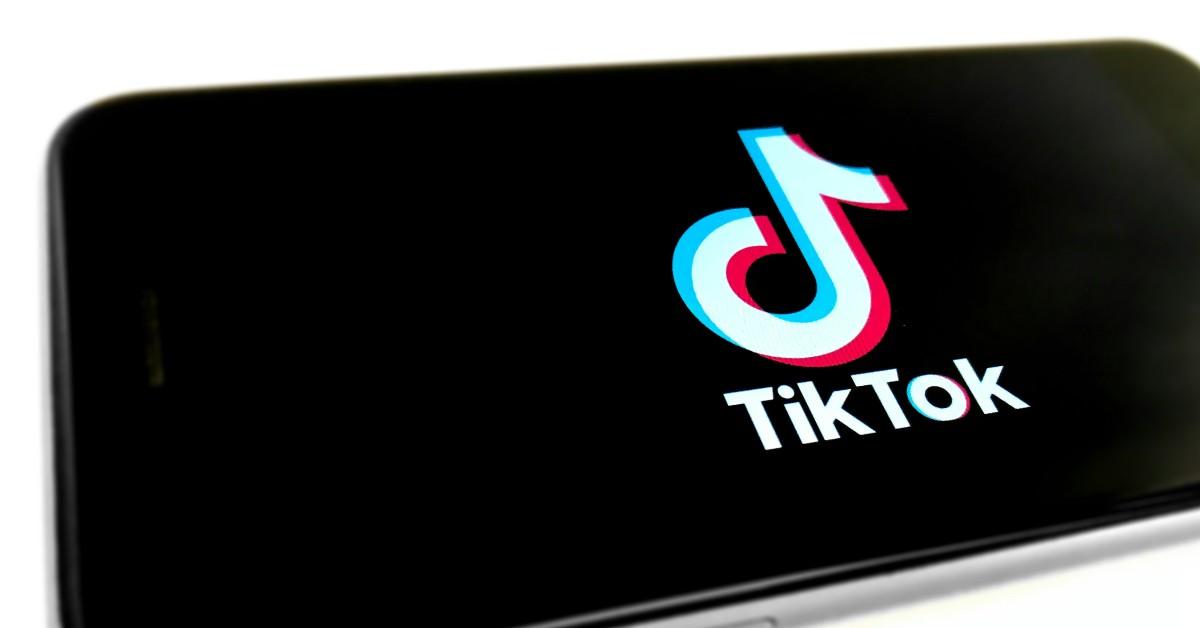 TikTok on the screen of a phone on a white background