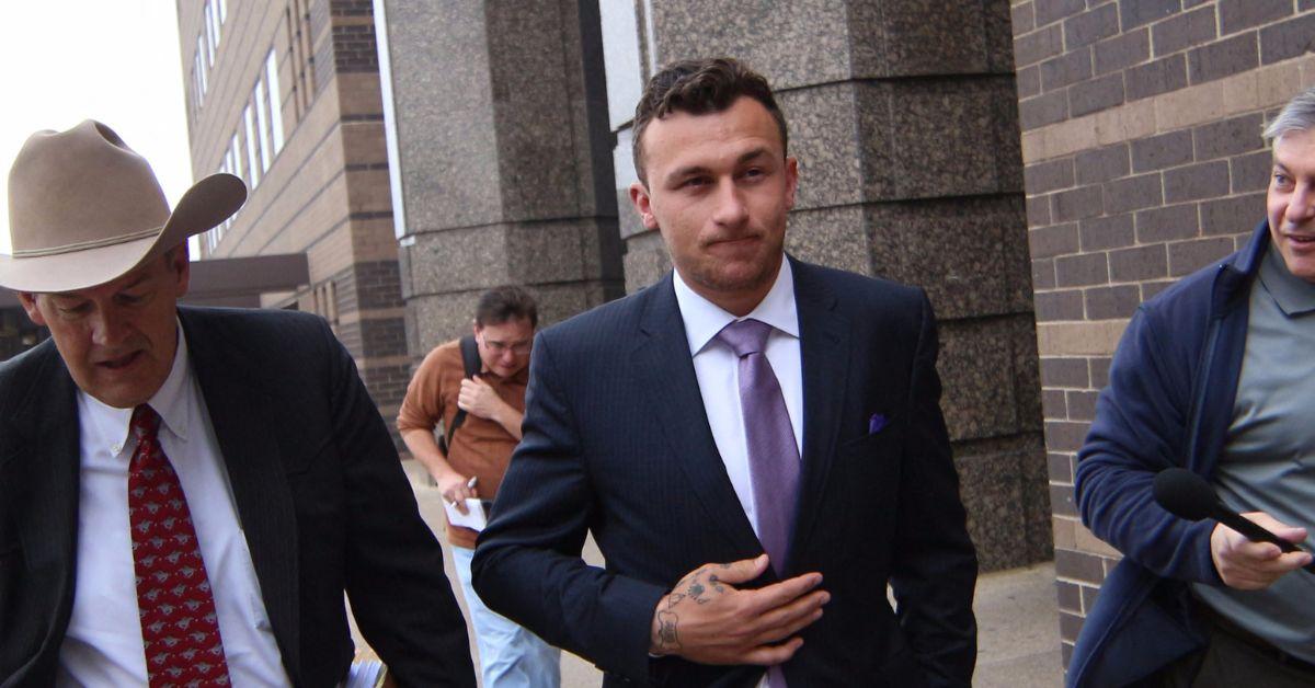 Johnny Manziel leaves a courthouse followed by reporters