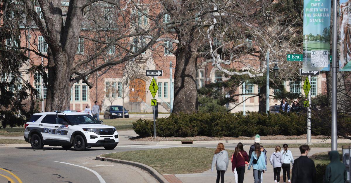 A police car on a street near a college campus in Michigan.