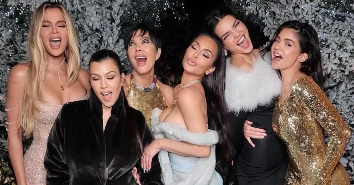 The Kardashian-Jenner family in front of white-tipped trees