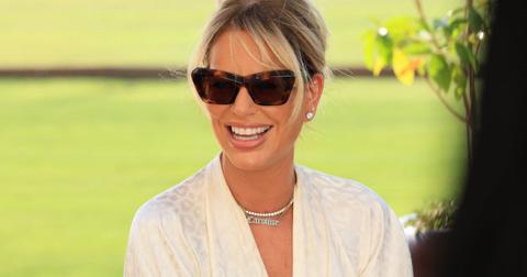 Caroline Stanbury smiles while wearing sunglasses in an outdoor setting during an episode of 'RHODubai'